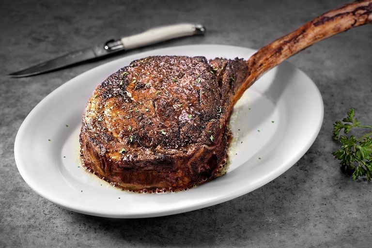 Ruth’s Chris Steak House signature dishes Petite Filet, Tomahawk Ribeye, Sizzling Blue Crab Cakes, Lobster Mac & Cheese
